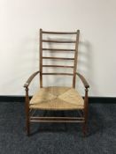 A pine rush seated high backed child's armchair