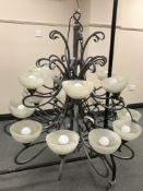 An impressive bespoke metal multi-branch chandelier with eighteen marbled glass shades