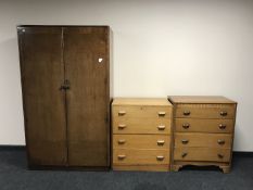 An oak double door wardrobe together with two oak four drawer chests (odd)