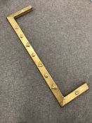 An early 20th century brass fire curb