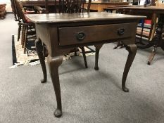 A Georgian oak side table on Queen Anne style legs fitted with a drawer