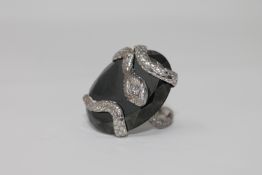 An unusual 18ct white gold and diamond set snake ring