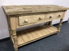 A reclaimed pine two drawer side table,