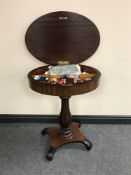 A late 19th century mahogany sewing table on pedestal