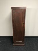 A wooden gun cabinet with keys