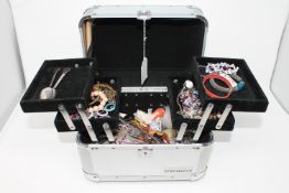 A jewellery box containing a quantity of costume jewellery, trinkets, watch straps,