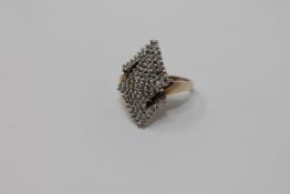 A diamond cluster ring, upon a yellow gold shank,