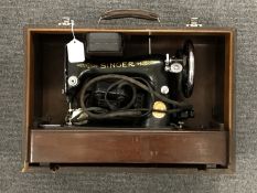 A cased Singer electric sewing machine
