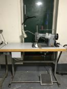 A Singer industrial sewing machine in table