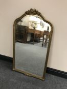 An ornate arch topped gilt framed mirror