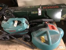 A Bosch pressure washer together with a boxed Bosch electric hedge trimmer