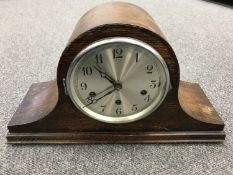 An oak cased mantel clock with silvered dial CONDITION REPORT: The pendulum is