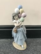 A Lladro figurine girl with balloons,