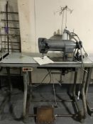 A Singer industrial sewing machine in table