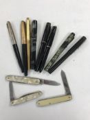 A collection of Parker and other pens, several with gold nibs,