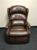 A brown leather manual adjusting armchair