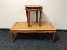 An oriental style rectangular hardwood coffee table together with circular lamp table