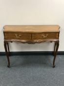 A 20th century inlaid mahogany continental serpentine fronted side table fitted two drawers