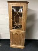 A pine glazed door corner cabinet