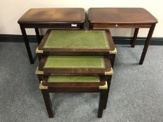 A nest of three leather topped tables and a pair of lamp tables