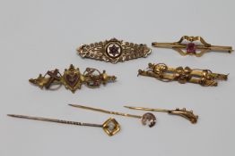 Four gold brooches and three gold pins CONDITION REPORT: The pin set with a pearl is