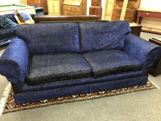 A Delcor three-seater settee upholstered in crushed blue velvet,
