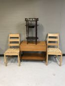 A pair of pine rush seated chairs together with a teak drop leaf trolley fitted with a drawer and a