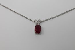 An 18ct white gold ruby and diamond pendant,