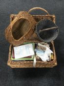 A wicker hamper containing sewing items together with three wicker hand baskets