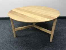 A circular contemporary beech coffee table