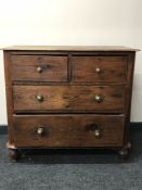 An antique pine four drawer chest with brass handles