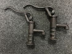Two miniature cast metal water pumps