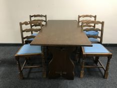 An oak refectory table together with a set of five oak ladder back chairs