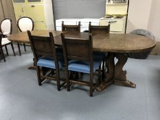 An oval oak twin pedestal dining table with extension leaf,