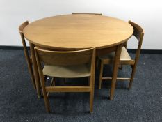 A circular 1970's teak extending dining table,