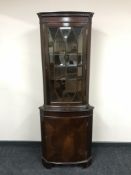 A mahogany corner display cabinet