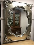 An ornate silvered framed mirror,