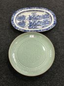 A Willow pattern meat plate together with a Chinese celadon plate CONDITION REPORT: