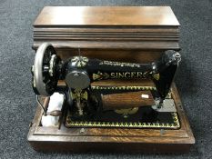 A mid twentieth century oak cased Singer hand sewing machine