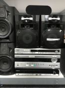 A Samsung DVD player together with four tower speakers ,a Onkyo DVD player and an amplifier,