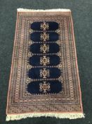 An Eastern rug on blue ground, 160 cm x 93 cm.