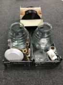 Two baskets containing two glass compots together with assorted brass ware, two cut glass decanters,