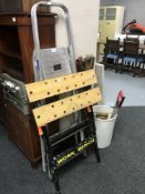 A set of aluminium folding steps, together with a work bench,