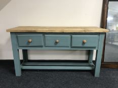 A reclaimed pine kitchen prep table fitted with three drawers on painted base