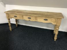 A reclaimed pine kitchen prep table fitted with three drawers