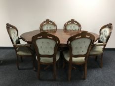 A shaped Italianate pedestal dining table with six chairs comprising of two carvers and four
