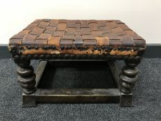An antique oak leather upholstered foot stool