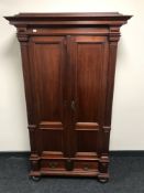 An early 20th century pine double door cabinet fitted a drawer