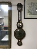 A mahogany banjo barometer with brass dial