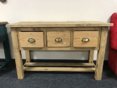 A reclaimed pine kitchen prep table fitted with three drawers